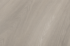 Close-up view of the authentic wood grain texture and matte finish of ArmorCore Arctic Mist Oak flooring.