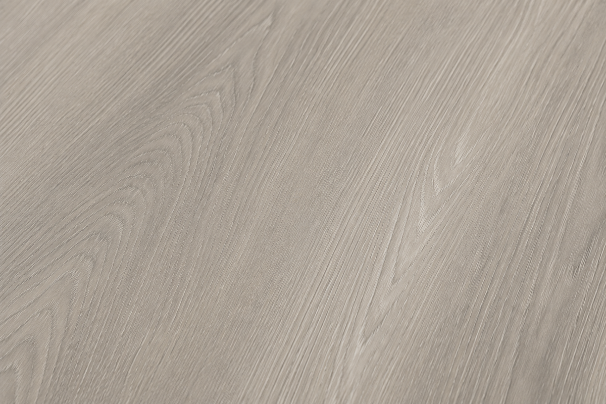 Close-up view of the authentic wood grain texture and matte finish of ArmorCore Arctic Mist Oak flooring.
