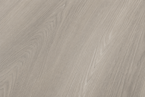 Close-up view of the authentic wood grain texture and matte finish of ArmorCore Arctic Mist Oak flooring.