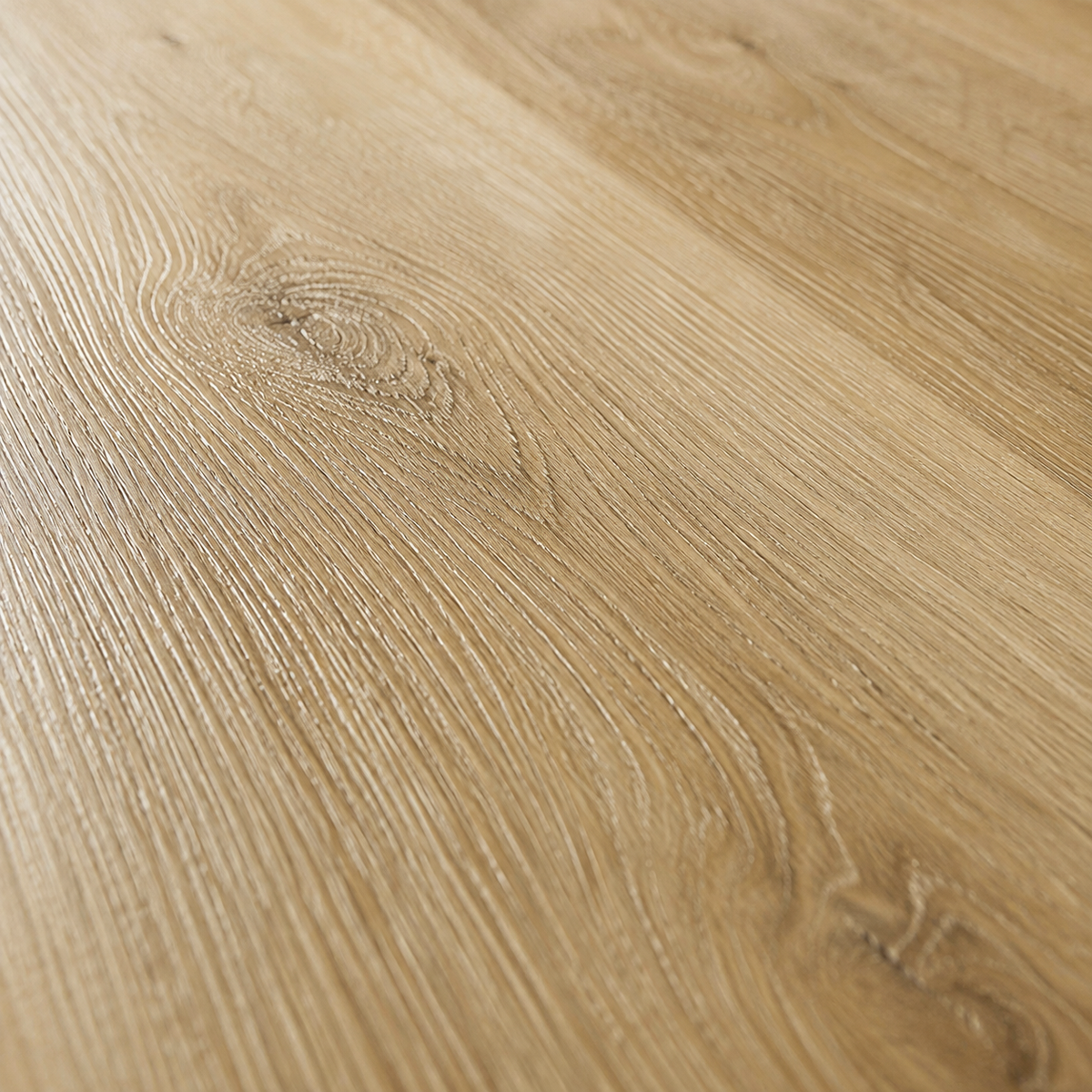 Close-up of a light oak wood grain surface with visible natural knots and linear texture.